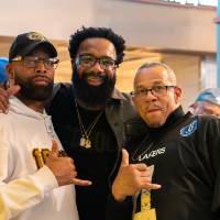 Three gentlemen attending event standing and posing for photo